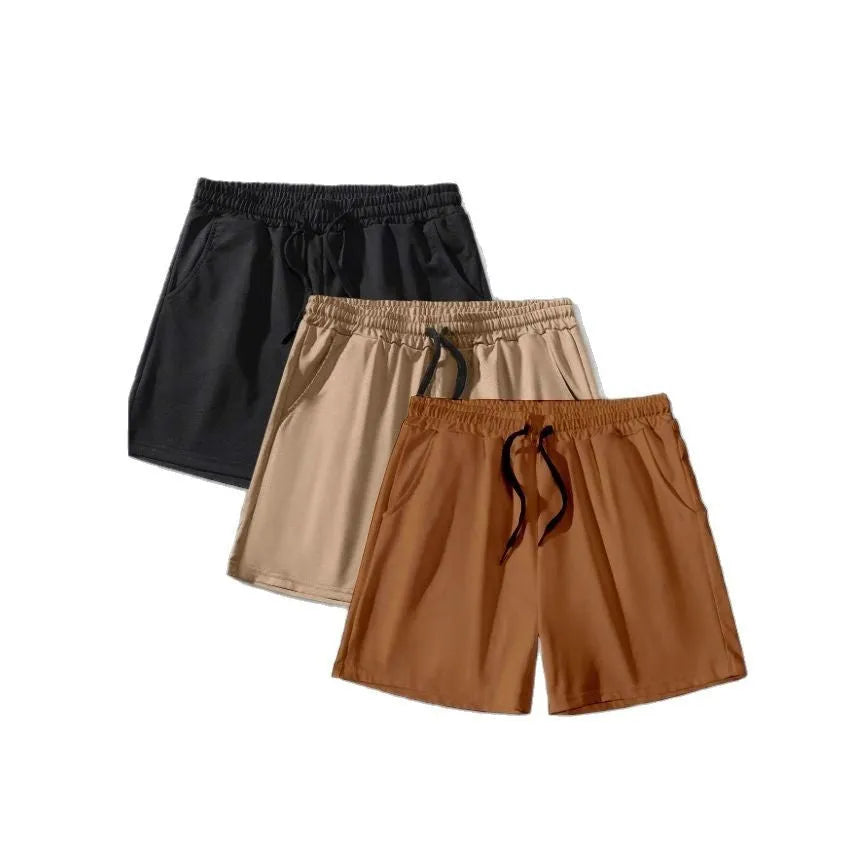 Men's solid colour drawstring shorts in black, khaki, and light brown from a 3-pack, loose fit.