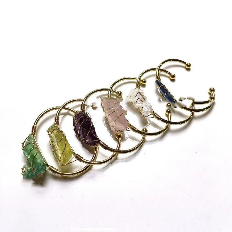 Geometric bracelet made of natural rough crystal stones wrapped with gold-coloured wire