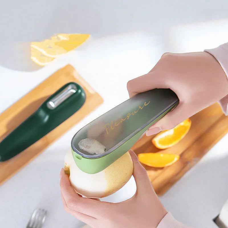 Dark green peeling knife with a storage tube and stainless steel blade on a kitchen worktop.