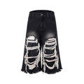 Model wearing black cropped wide-leg jeans with a distressed patch detail on the leg.