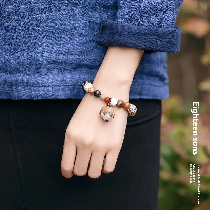 Handmade brown bodhi seed beads bracelet with 18 beads, shown on a wrist.