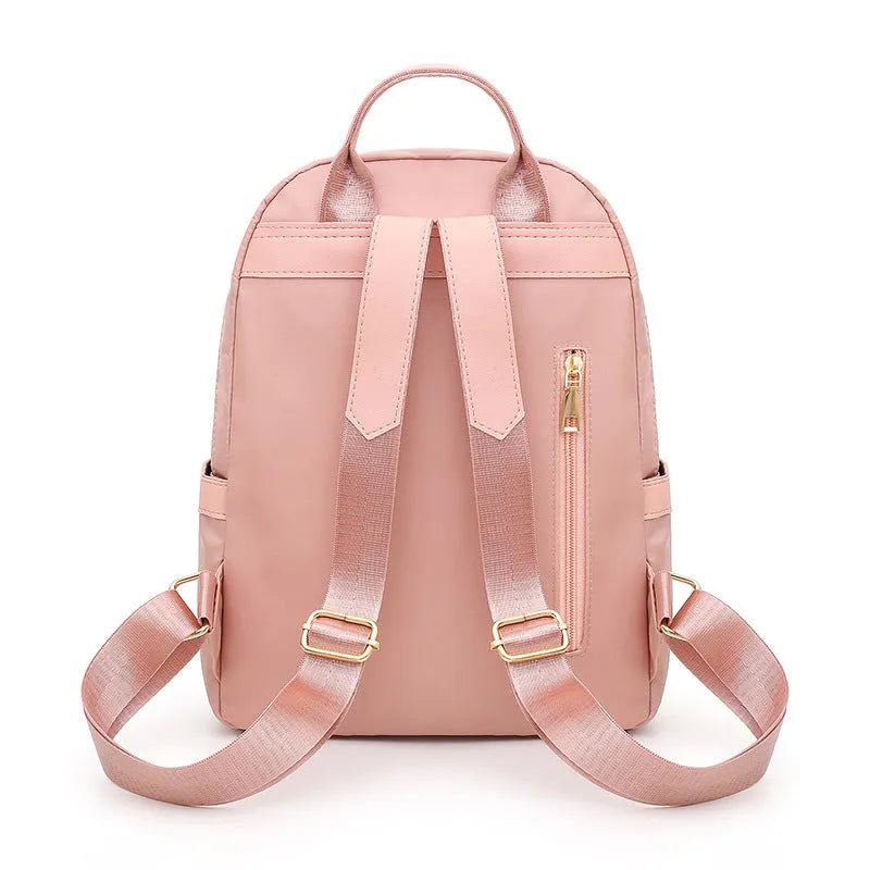 Black and pink women's casual nylon backpack showing soft surface and shoulder straps