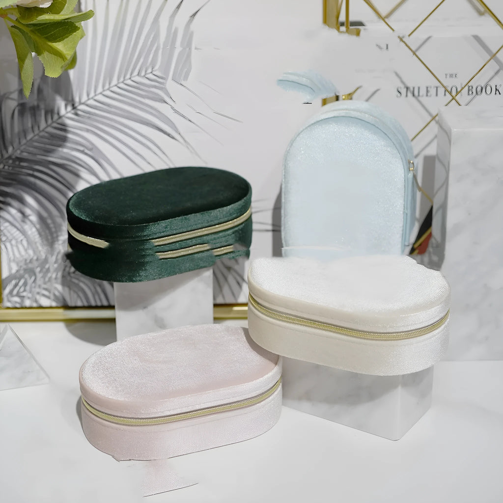 Oval velvet jewellery storage box in lake blue with flannel interior and removable hook.