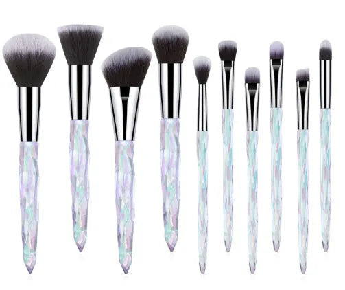 10 clear crystal handle foundation brushes with diamond shanks, showing black, blue, red, and yellow colour options.