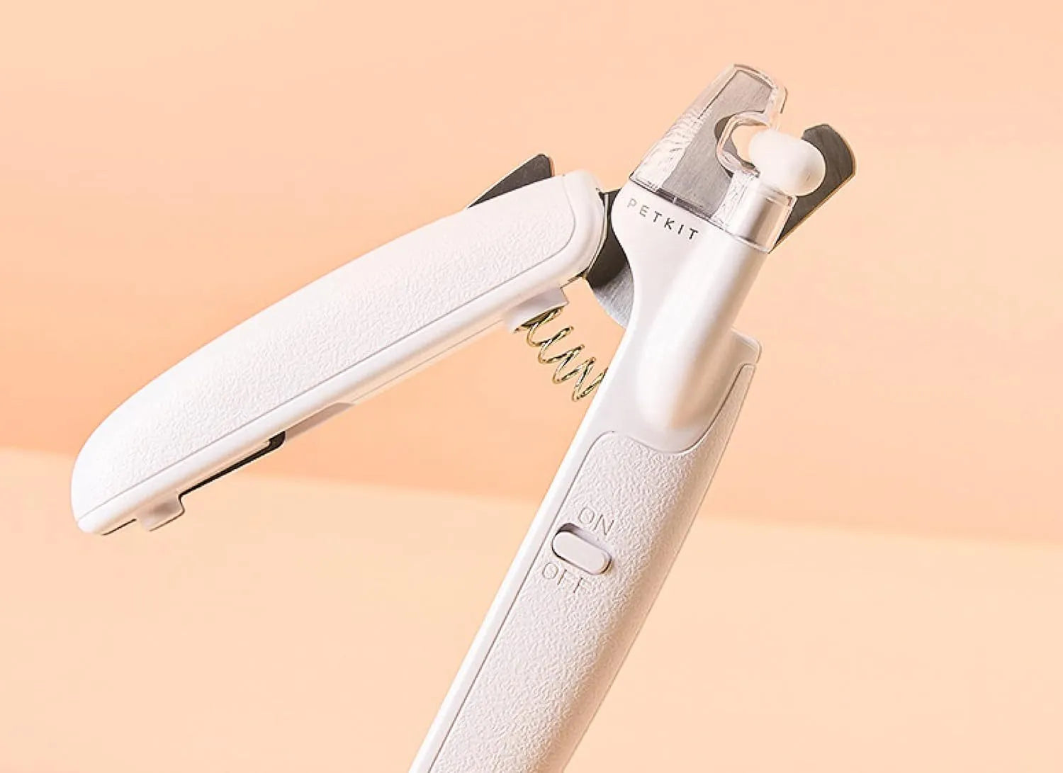 White LED pet nail clippers with a transparent guard open, showing the triangular blade and integrated nail file.