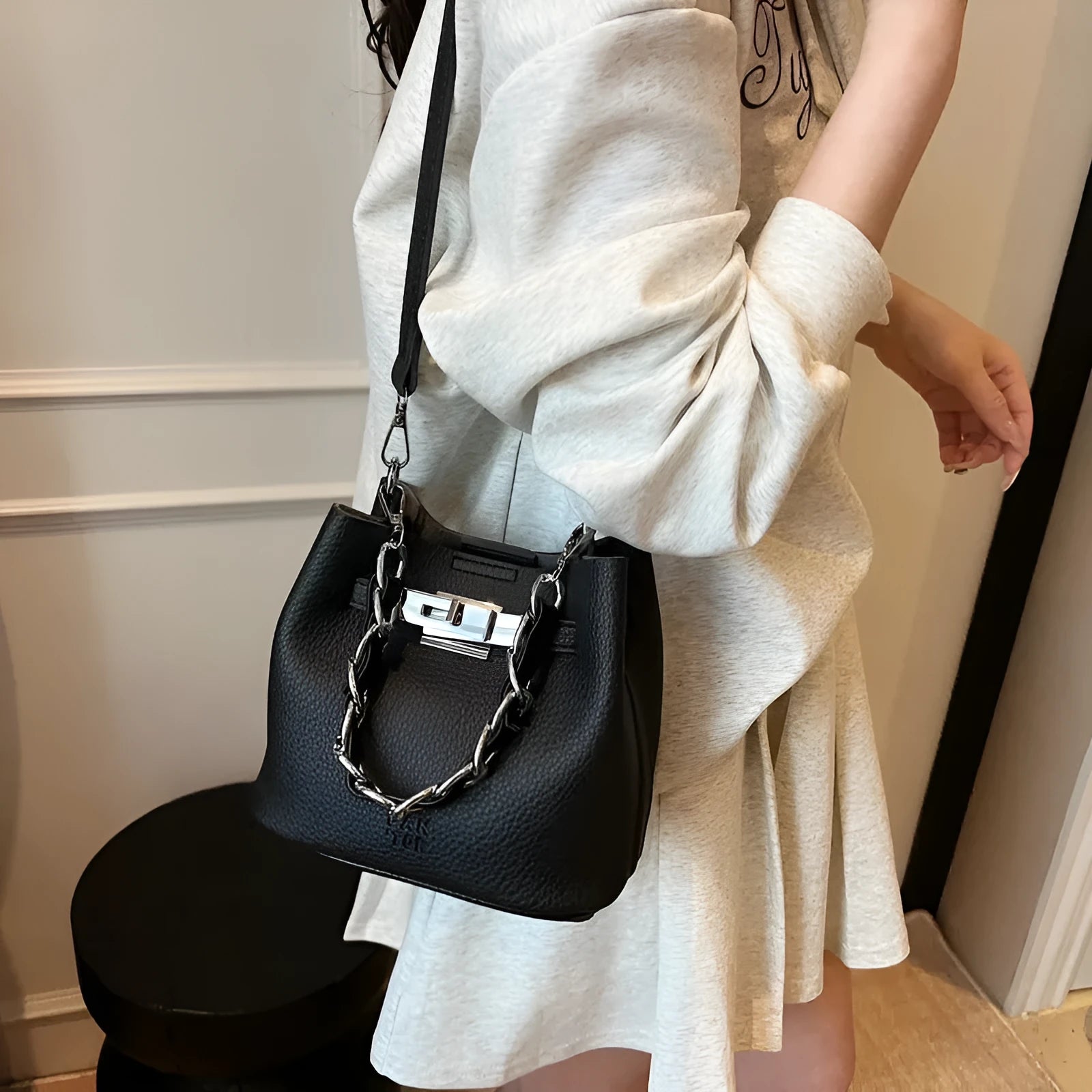 Soft PU leather retro bucket shoulder bag in black showing internal organiser pockets.