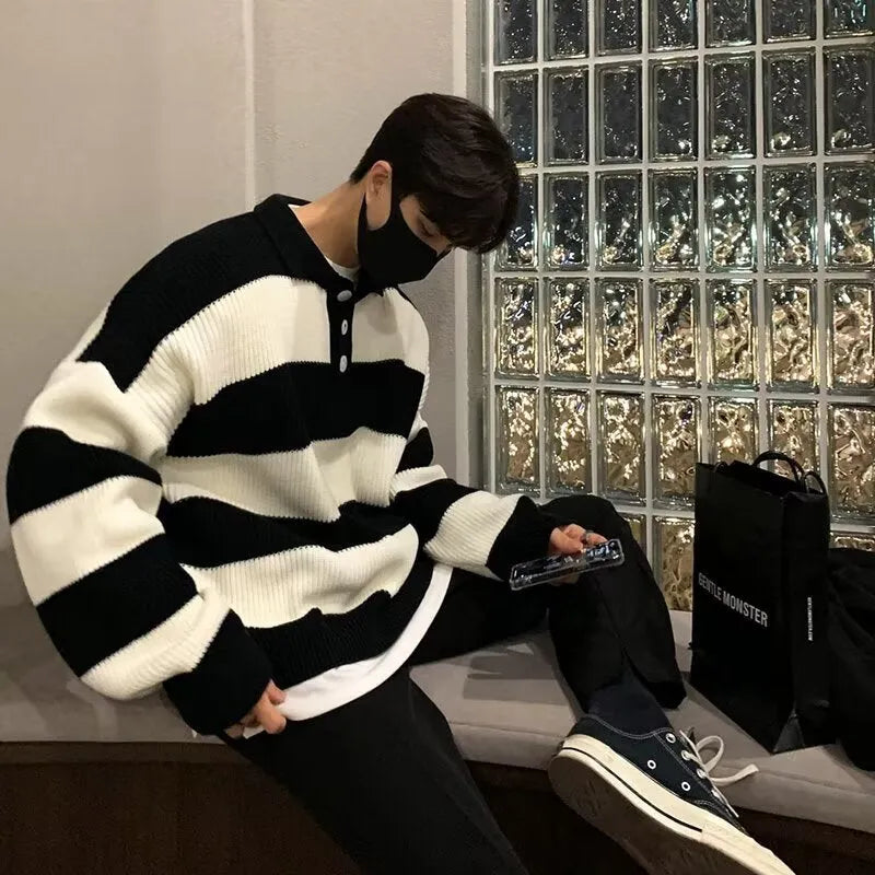 Man modelling a loose-fit black and grey striped polyester sweater coat, a long-sleeve pullover.