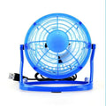 Black mini USB desk fan with adjustable angle on a wooden desk.