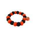 Orange Halloween cat collar with plastic pumpkin, ghost, and bat charms on a black strap.