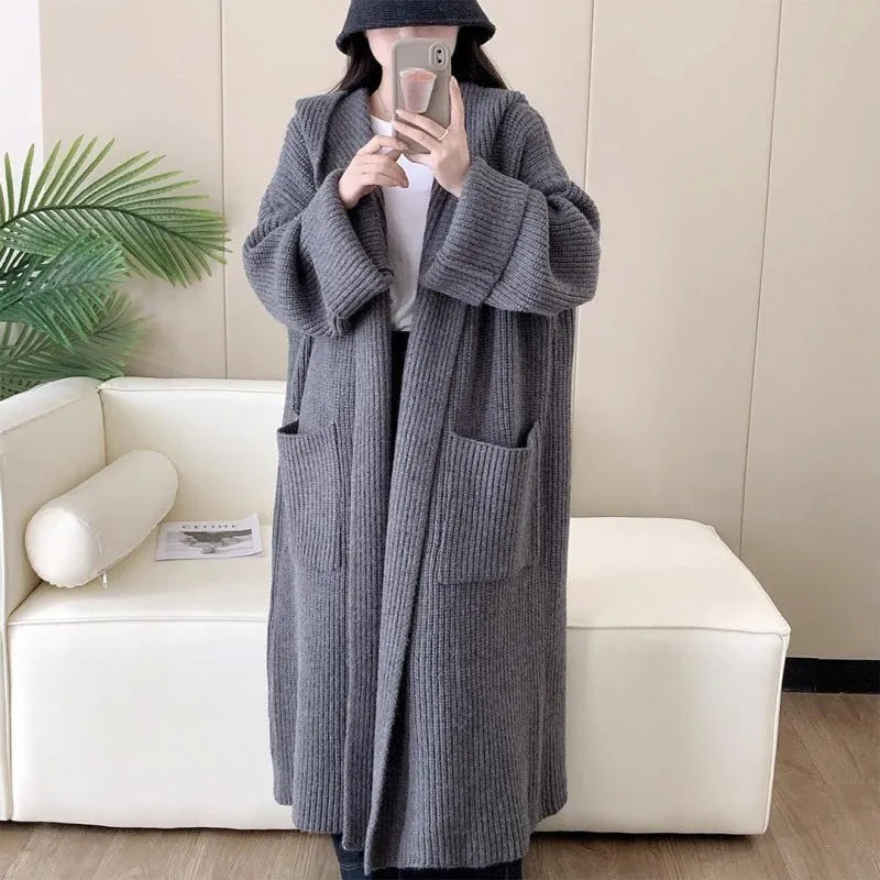 Women's milky white loose hooded cardigan coat with long raglan sleeves on a hanger.