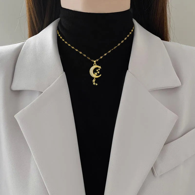 Geometric moon tassel necklace with diamond detail on a stainless steel chain.