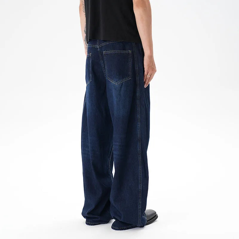 Dark blue wide-leg jeans with a distressed wash on a denim fabric, showing a relaxed fit.
