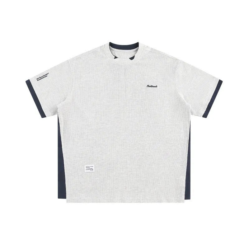 Retro alphabet embroidered loose waffle knit t-shirt in navy blue, shown on a hanger.