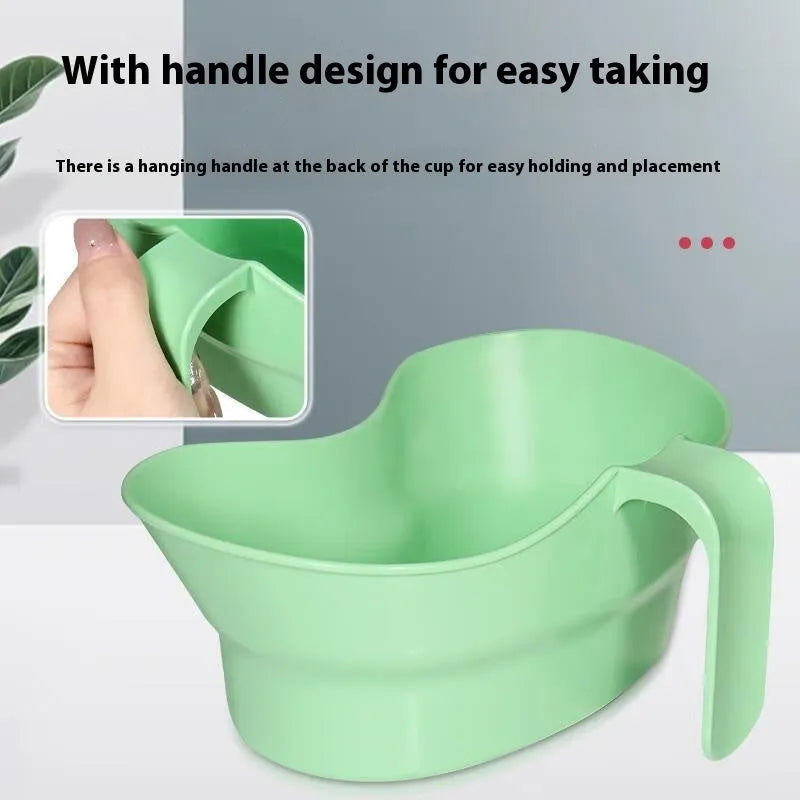 Green plastic bedridden patient gargle cup for nursing care and oral hygiene.