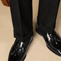 Men's black polished leather tassel loafers with rubber soles for business casual wear