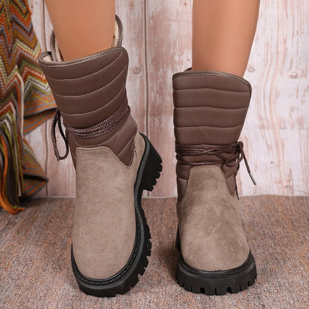 Women's black suede snow boots with chunky heel, fleece lining, and lace-up design.