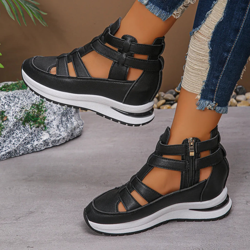 Black women's close-toed hollow-out platform sandals with Velcro strap on a white background