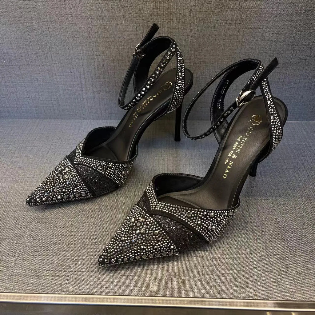 Women's black high-heeled shoes with a red sole, showing stiletto heel and pointed toe design.