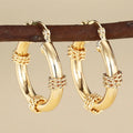Geometric copper ring ear clip earrings in golden finish with linear design details