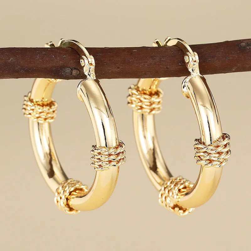 Geometric copper ring ear clip earrings in golden finish with linear design details
