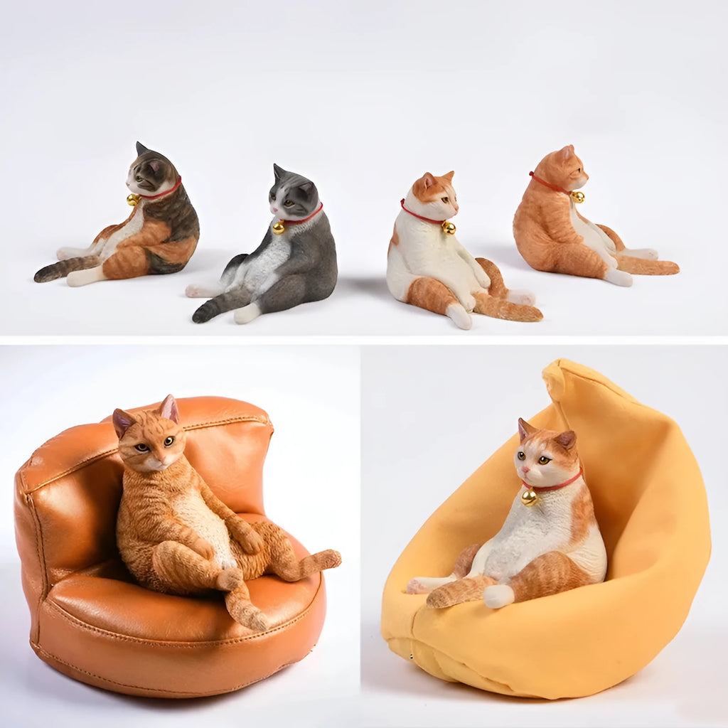 Small lazy cat figurine seated on a sofa, a 1:6 scale resin and fabric car dashboard ornament.