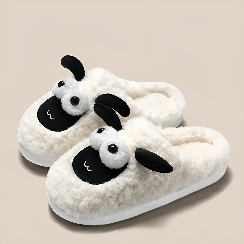Brown slip-on slippers with suede upper and lamb thermal cotton lining on wooden floor
