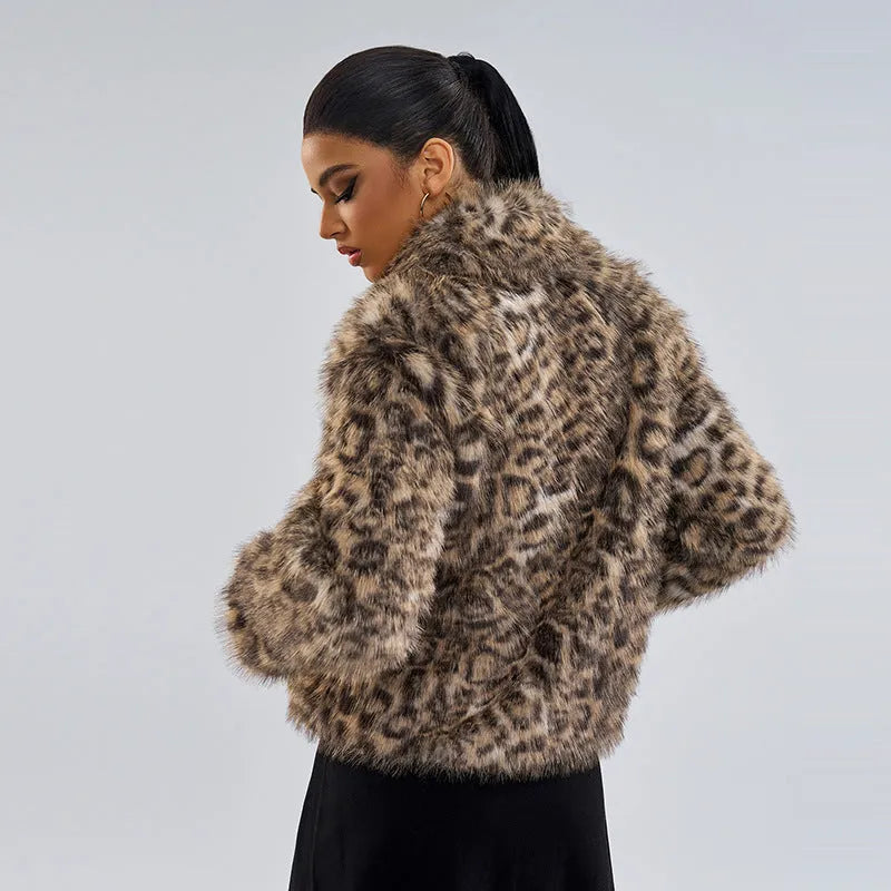 Women's leopard print coat with a buckle lapel fastener on a hanger.