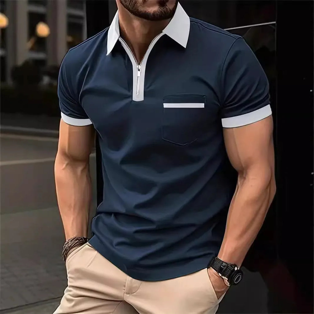 Man wearing a loose-fit short sleeve casual shirt with a chest pocket and zipper detail.