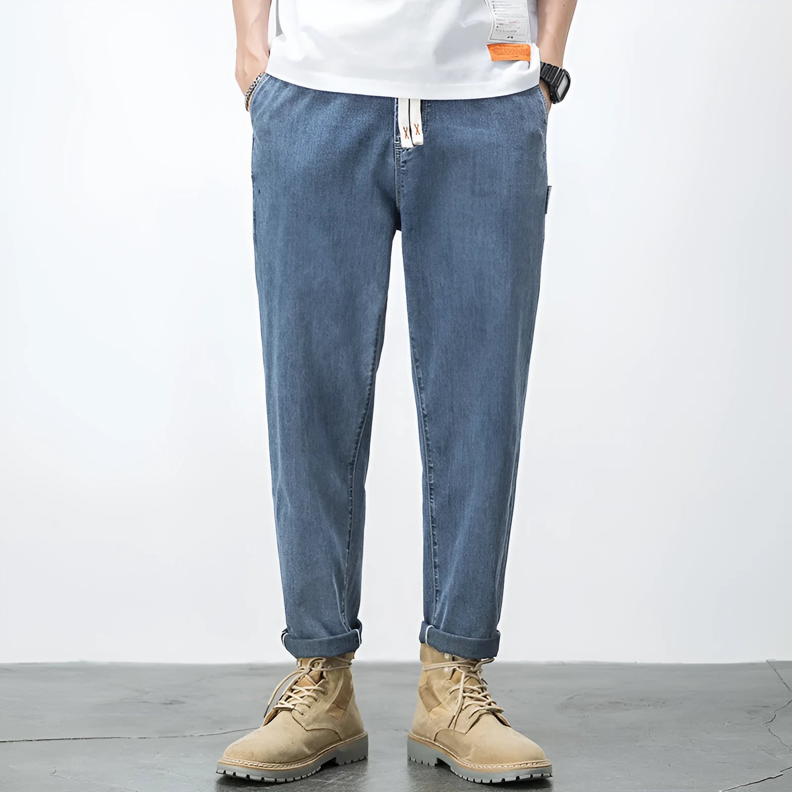 Men's loose plus size elastic waist jeans in blue cotton denim with mid waist straight leg fit