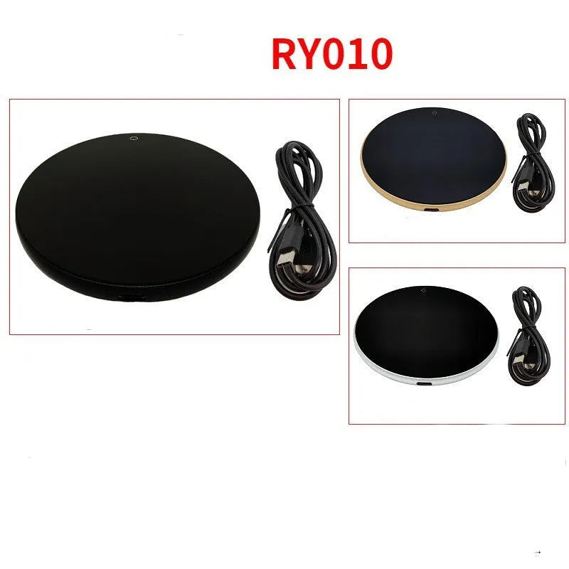 Black USB-powered beverage warming coaster with tempered glass top on a wooden desk