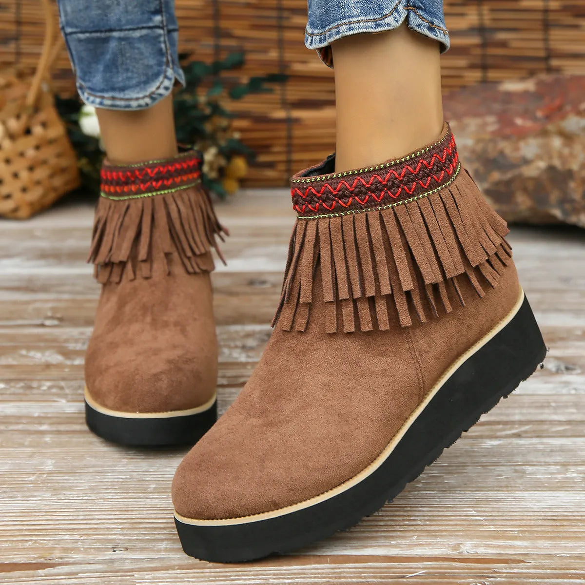Women's dark brown suede ankle boots with a thick wedge sole, side zip, and decorative tassel.