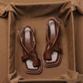 French retro brown toe ring sandals with square toe and ankle-strap buckle on a neutral background