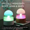 White cloud-shaped ultrasonic humidifier producing rainfall mist with colour-changing night light effects