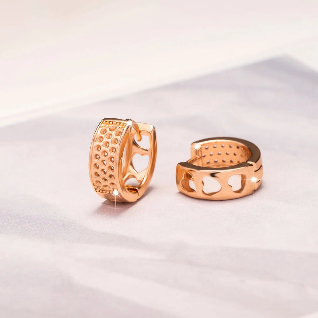 Rose gold women's earrings with three hollow heart shapes in circular arrangement