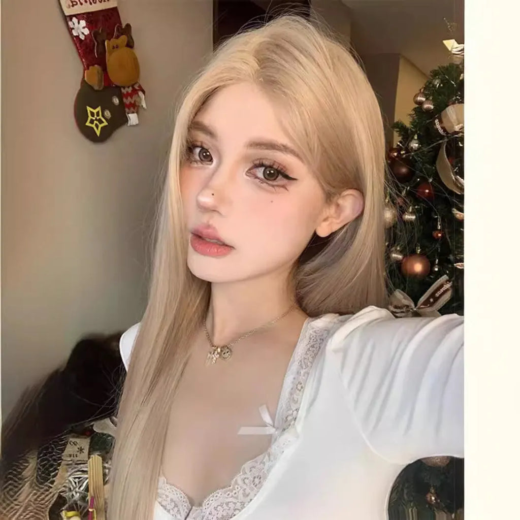 Long straight synthetic wig in milk tea blonde gold colour with hair net on display