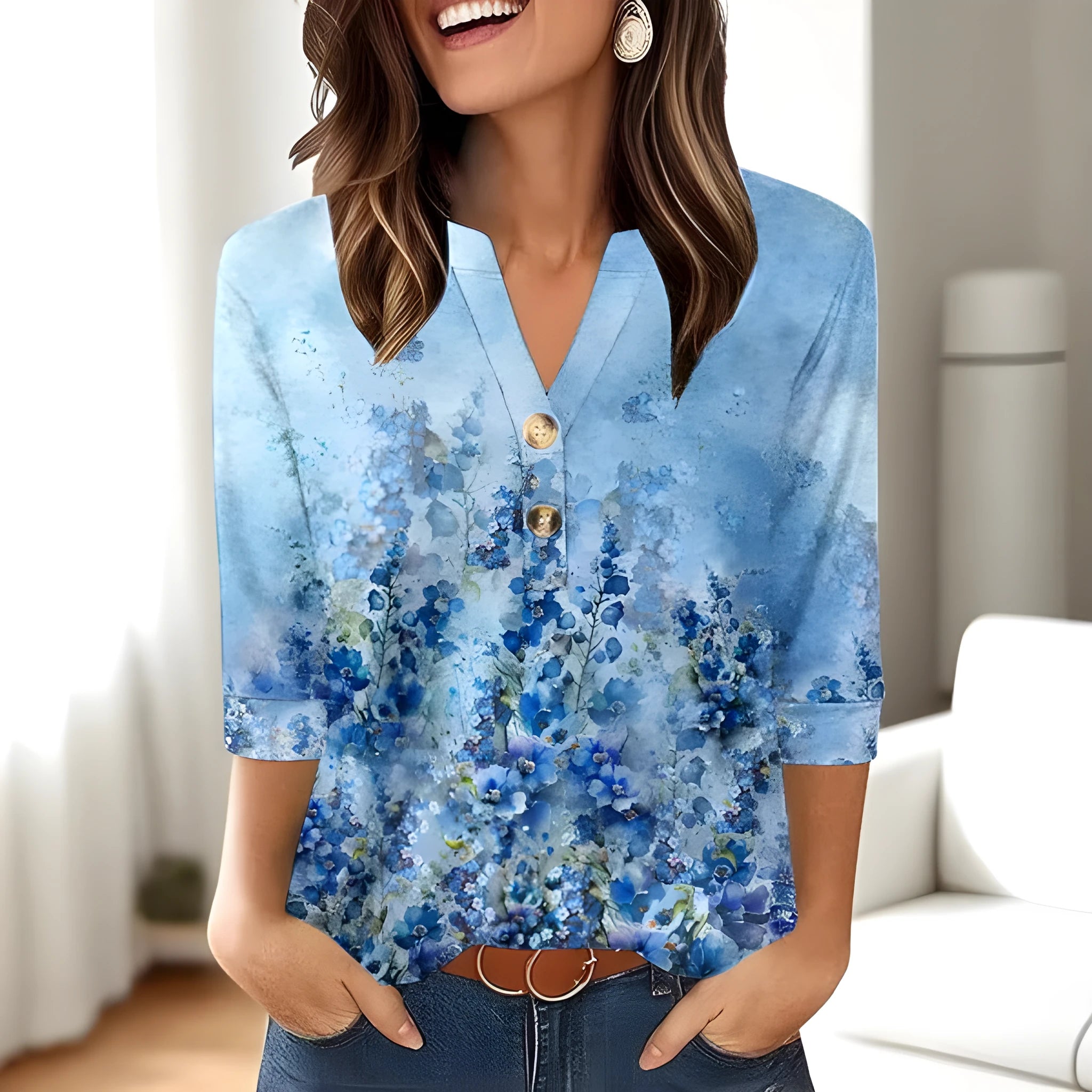 Woman wearing a loose-fit grey V-neck top with a colourful 3D geometric pattern print.