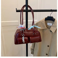 Retro brown PU leather women's pillow-shaped handbag with double shoulder strap and flap closure.