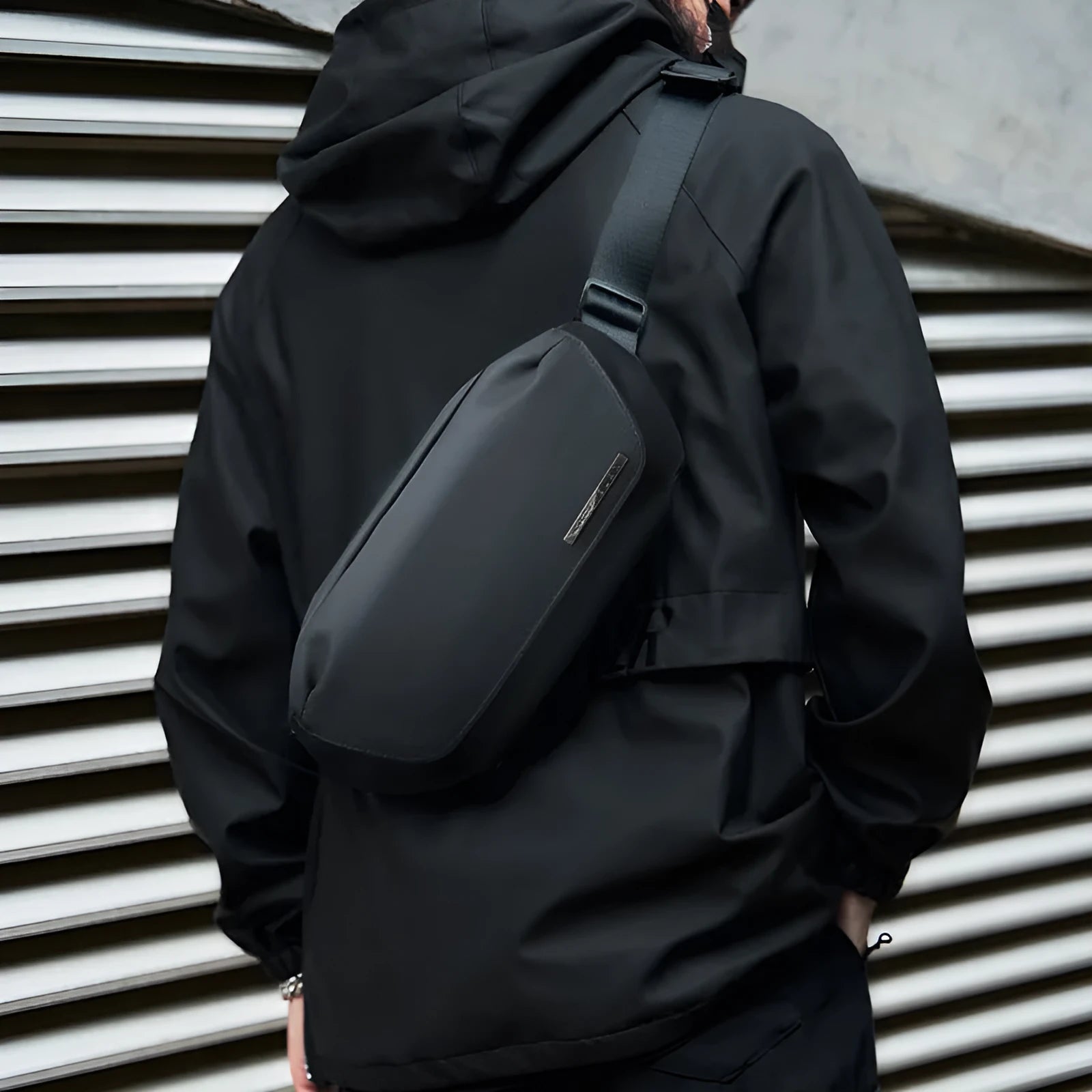 Black men's messenger bag made from Oxford cloth with a one-shoulder strap.