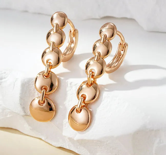 A pair of gold retro woven copper large circle hoop earrings.