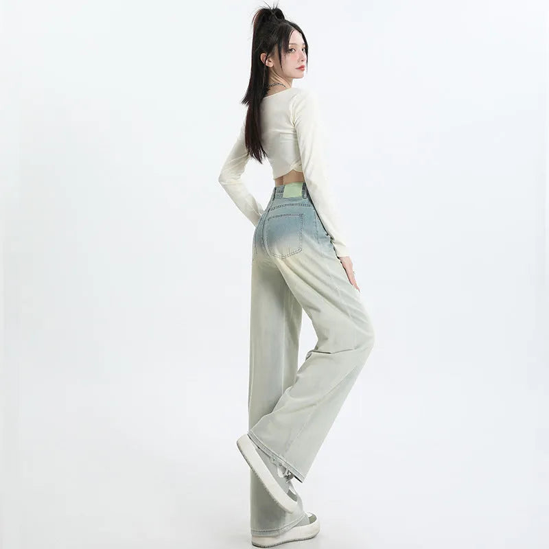 Gradient blue women's straight-leg denim trousers on a hanger, showing colour transition.