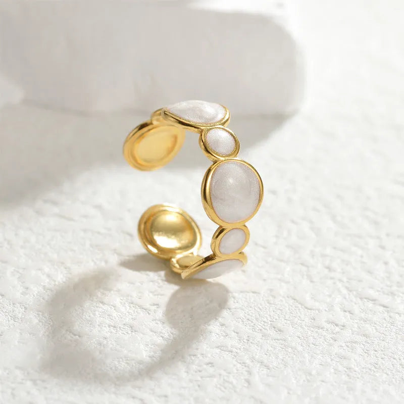 Adjustable stainless steel ring with a geometric shape and electroplated metallic finish.