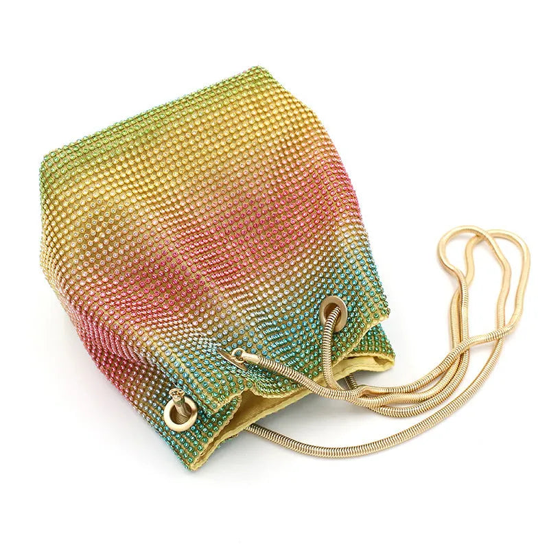 Colourful rainbow glitter rhinestone bucket bag with an adjustable metal chain strap.