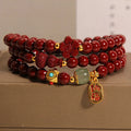 Red cinnabar bracelet with 6mm beads showing multi-circle gourd and five petal flower geometric design