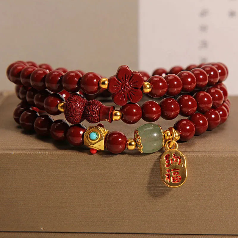 Red cinnabar bracelet with 6mm beads showing multi-circle gourd and five petal flower geometric design