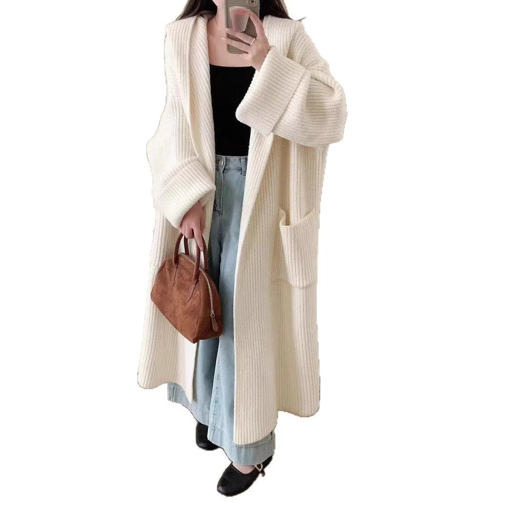 Women's milky white loose hooded cardigan coat with long raglan sleeves on a hanger.