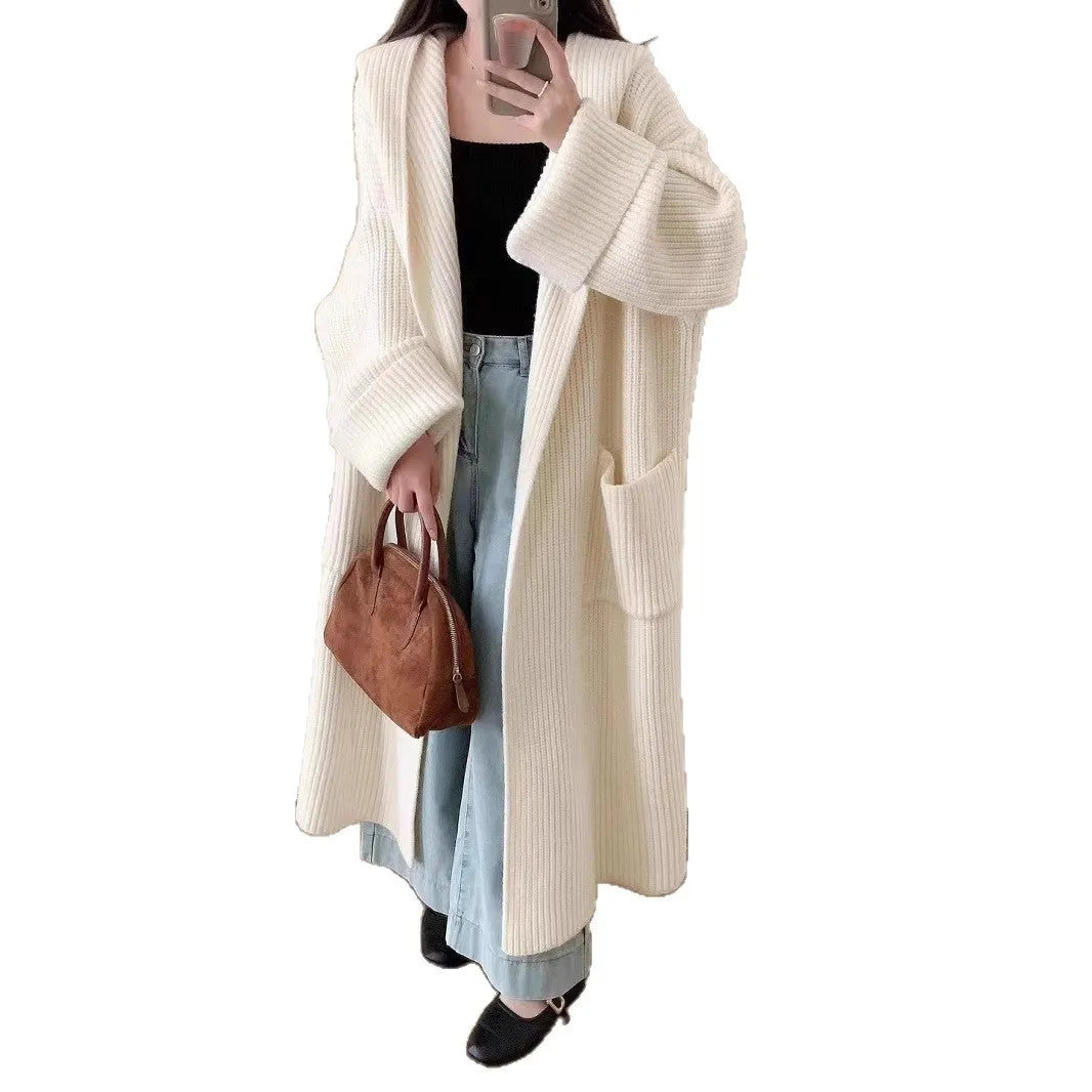 Women's milky white loose hooded cardigan coat with long raglan sleeves on a hanger.