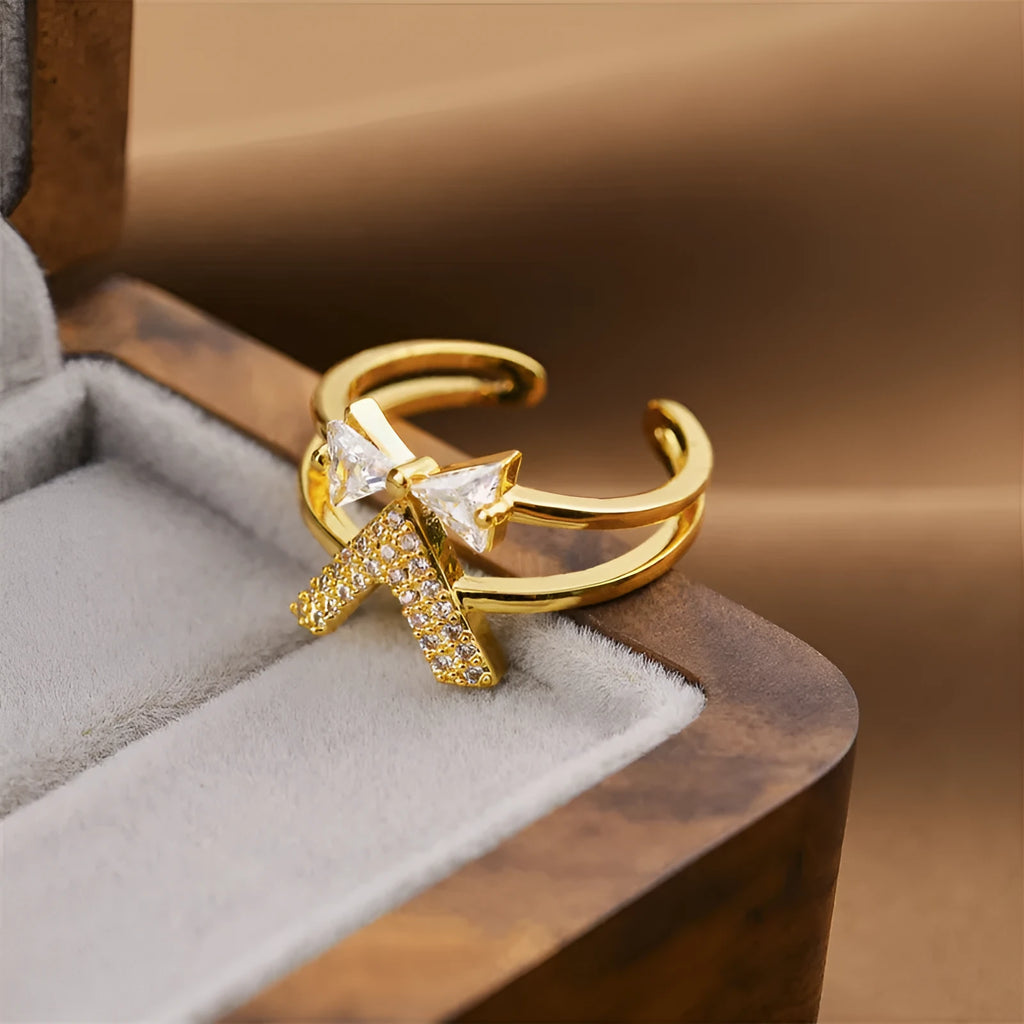 Gold open geometric women's fashion ring on a neutral background.