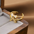 Gold open geometric women's fashion ring on a neutral background.