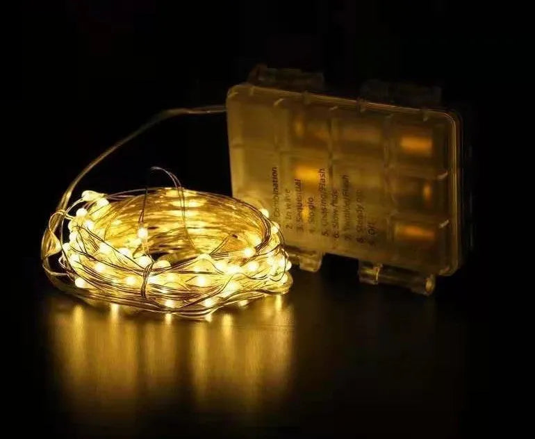 Copper wire decorative string light with 120 bulbs on a 12-metre cable, showing battery box and colour options.