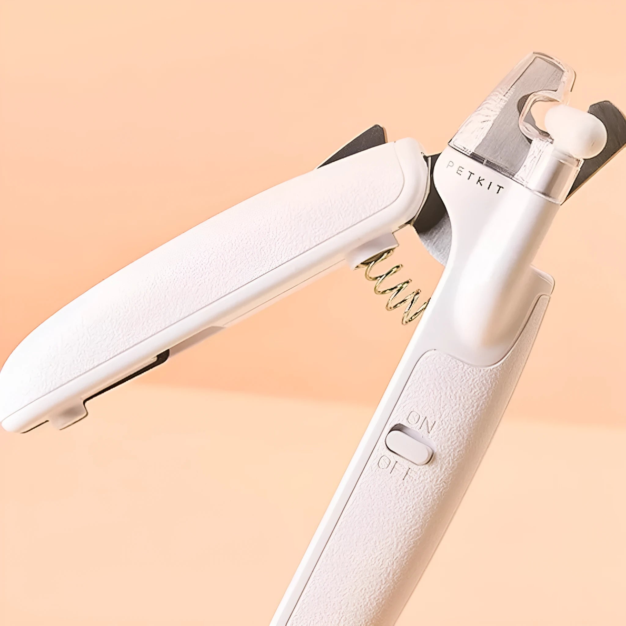 White LED pet nail clippers with a transparent guard open, showing the triangular blade and integrated nail file.